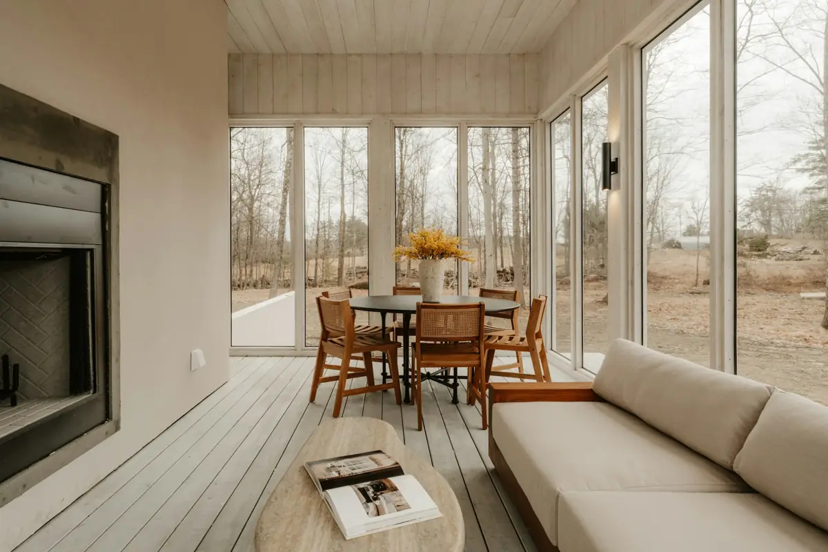 A bright room with a modern built-in fireplace and tall windows